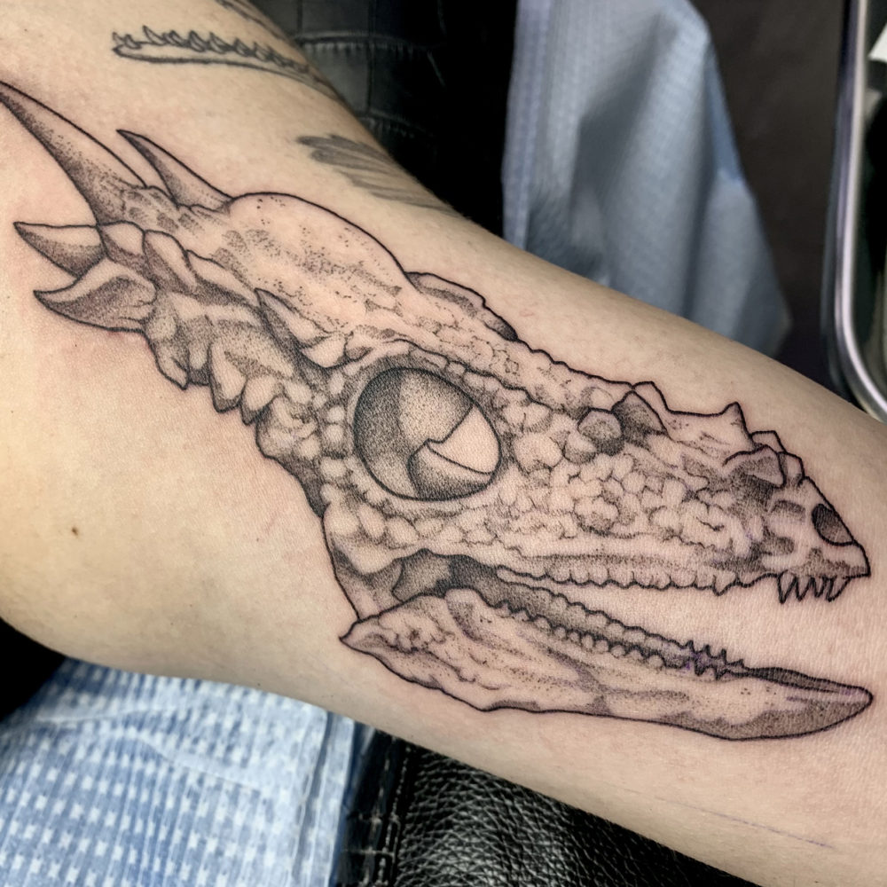 dinasour-skull-inner-bicep-tattoo