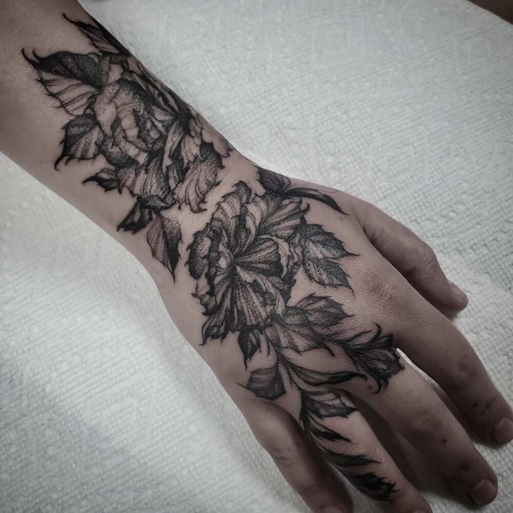 dark-roses-hand-arm-tattoo